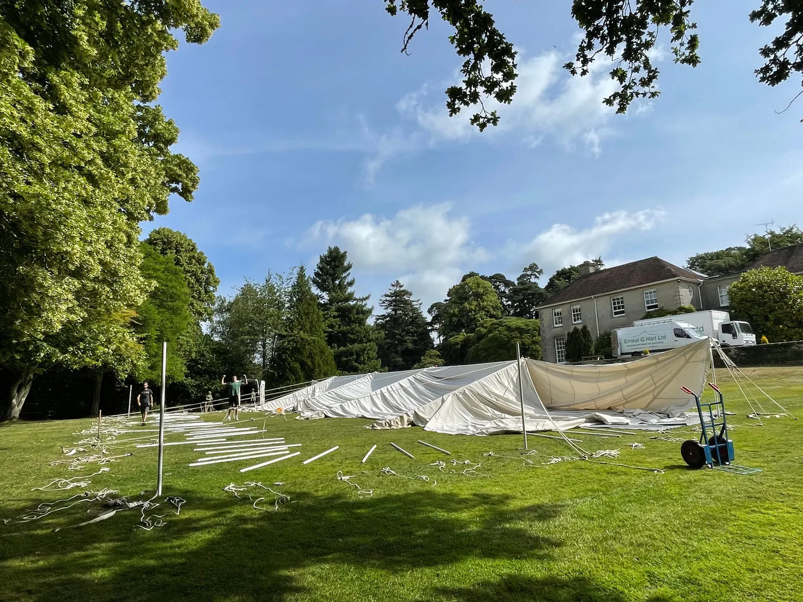 Canvas laid out on a lawn before pitching