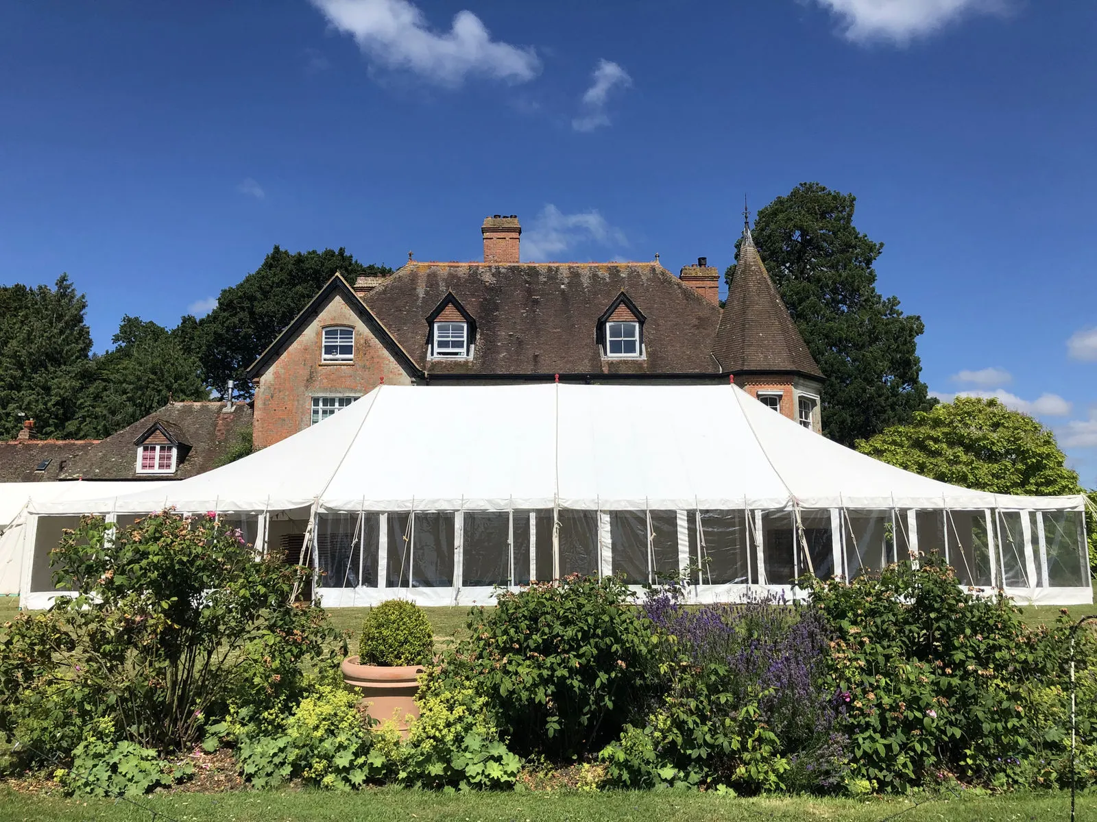Marquee in front of a red-brick country house