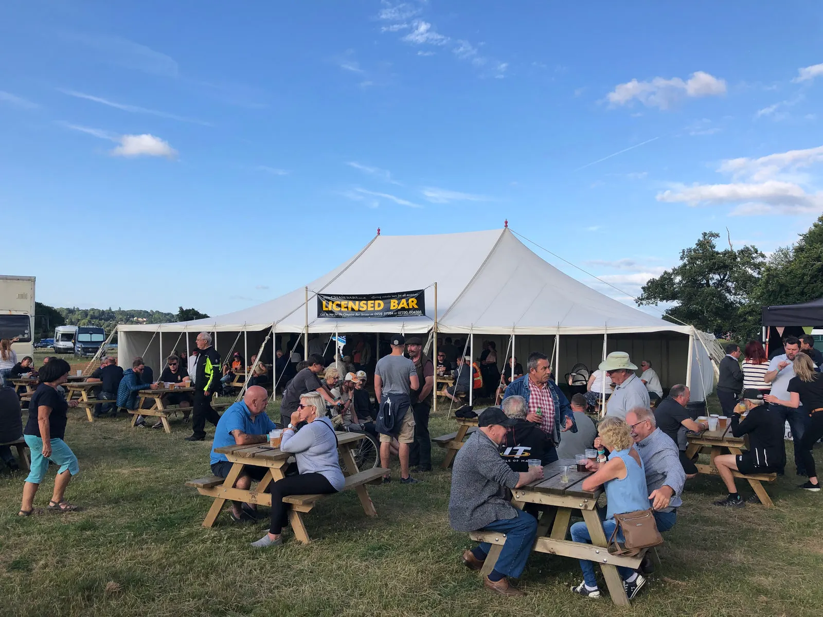 Festival-goers outside a licensed bar marquee