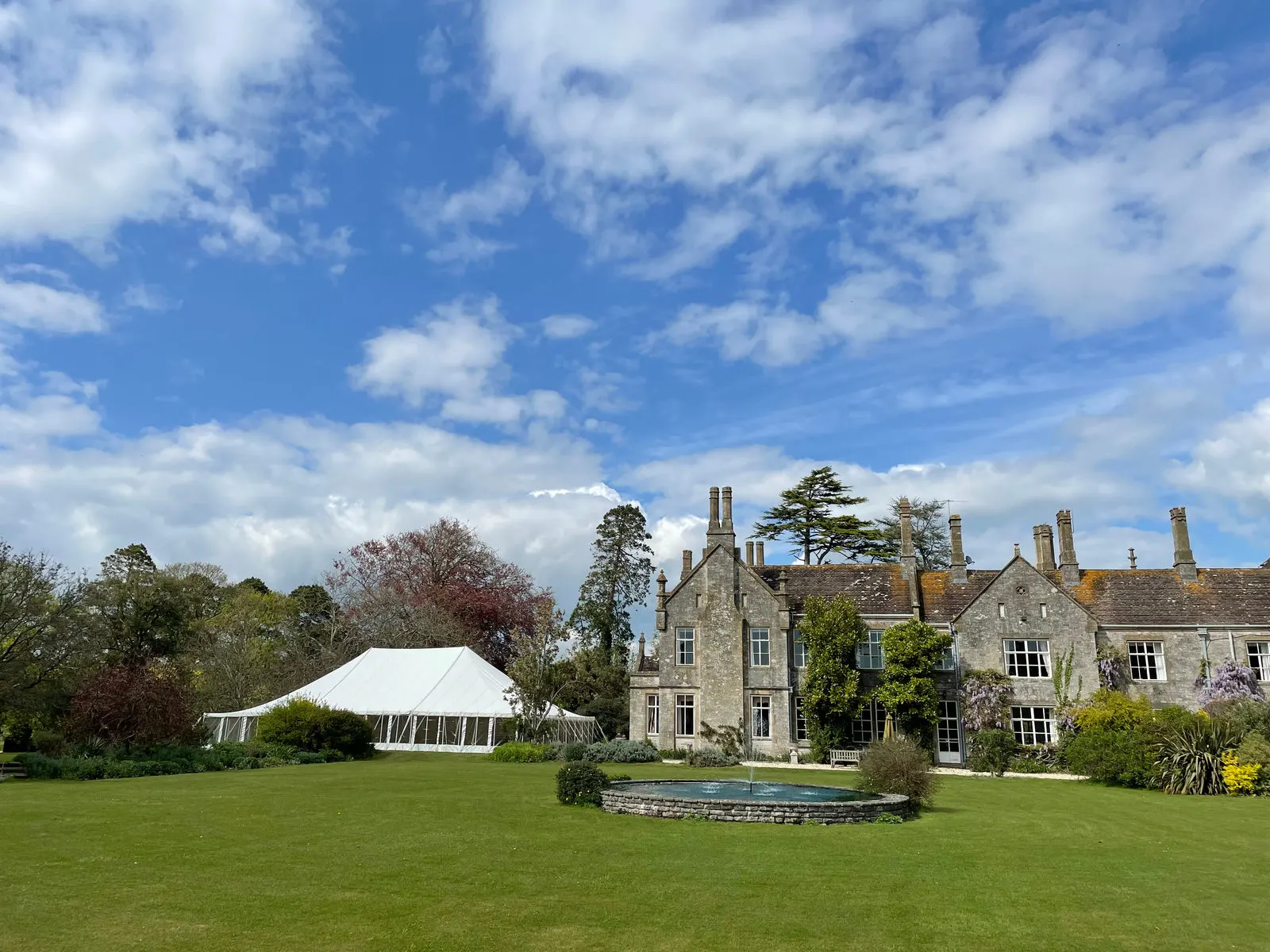 Marquee on the lawn of a stone manor
