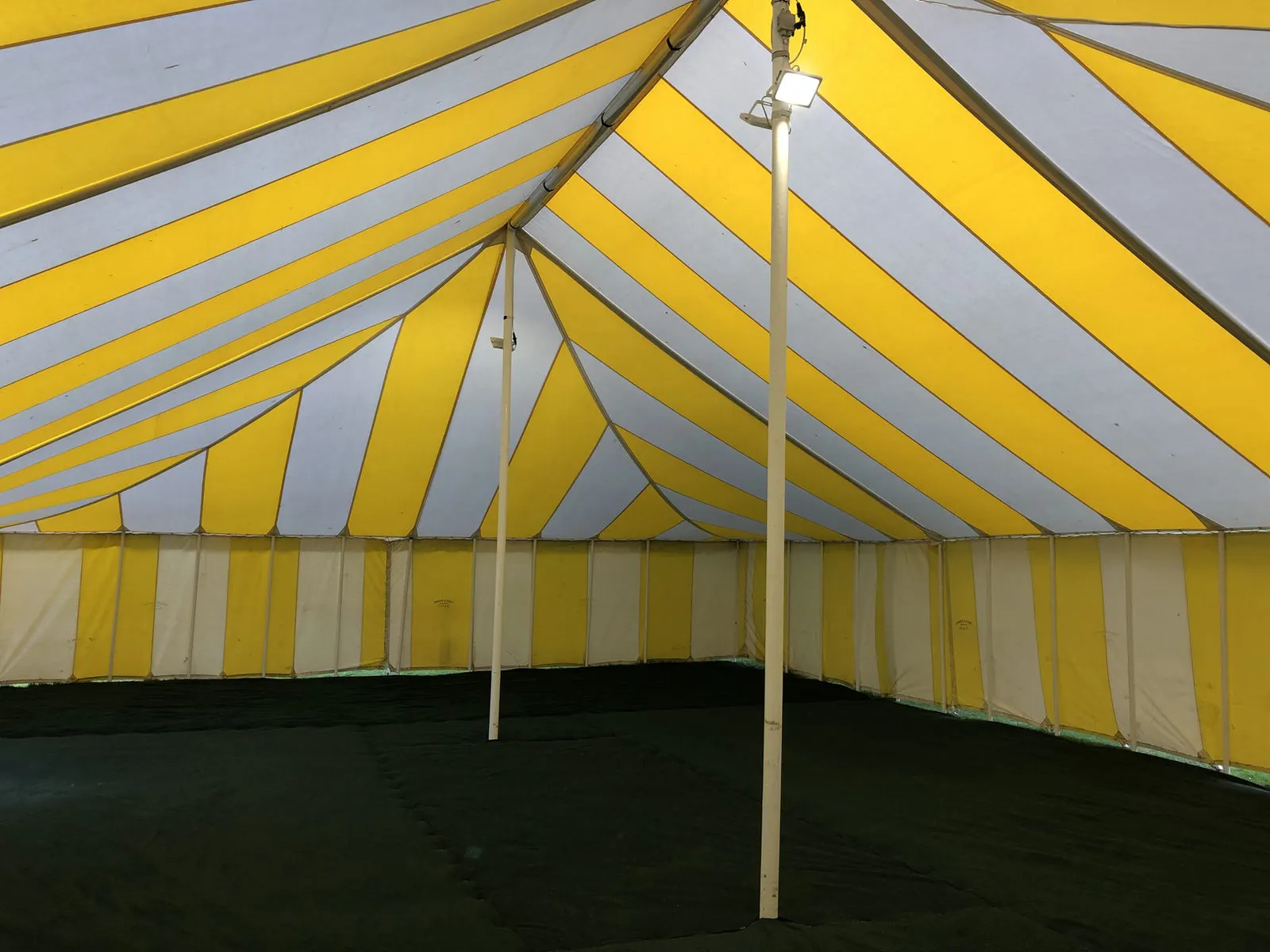 Inside a yellow and white striped marquee